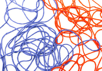 bright red and blue tangled threads on a white background