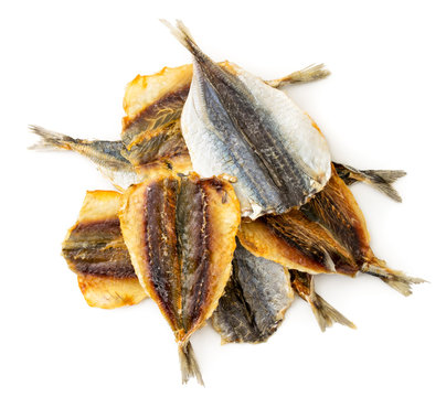 Dried yellow striped fish, selar group close-up on a white background, top view. Isolated