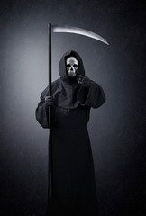 Grim reaper pointing at you in the dark