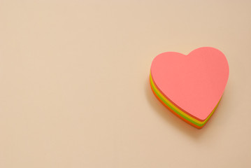 Heart shape paper note with a pen. Copy space