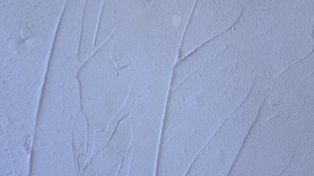 Putty wall aligning with plaster in room, renovation construction works and overhaul, closeup view. Finishing repairing works. Texture of gray cement wet plaster. Plastering coating wall surface.