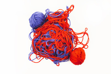 bright red and blue tangled threads on a white background