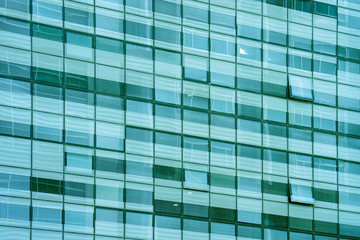 Obraz na płótnie Canvas Modern apartment buildings in new neighborhood. Glass blue square Windows of facade modern city business building skyscraper. Windows of a building, texture.