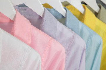 colourful collared shirts on white hangers