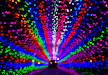 Blurry LED light tunnel on night for background.