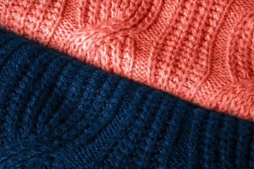 Stylish knitted fabrics of sweaters coral and classic blue color with a pattern.