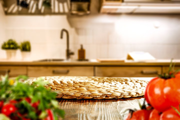 Kitchen vegetable chopping board with space for your product. Interior of fuzzy Italian kitchen furniture. White light from the lamp. Fresh vegetables and fruits.