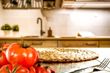 Kitchen vegetable chopping board with space for your product. Interior of fuzzy Italian kitchen furniture. White light from the lamp. Fresh vegetables and fruits.