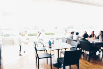 Fototapeta na wymiar Abstract blurred bokeh people sitting in hotel restaurant