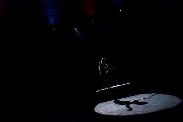 Fototapeta na wymiar silhouette of aerial acrobat on rope in circus