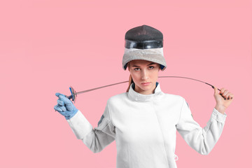 Young female fencer on color background