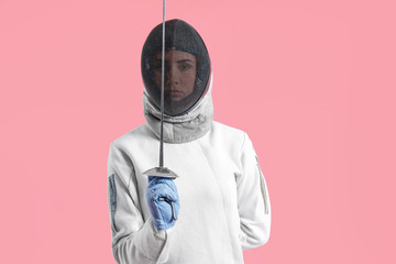Young female fencer on color background