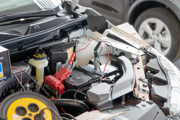 Fototapeta premium Process accumulator charging. Image of a car battery and jumper cables