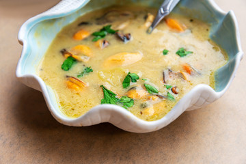 Traditional homemade greek mussels spicy soup cooked with olive oil and mustards