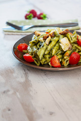 Penne cooked cereal specialty with cooked chicken fillets and a sauce made with olive oil