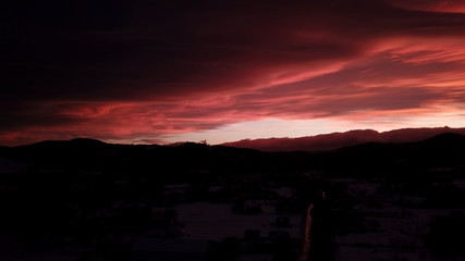 Beautiful dramatic red sunset in winter mountains
