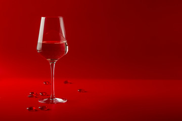 Full glass of wine over red background