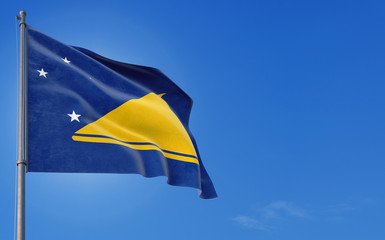 Tokelau flag waving in the wind against deep blue sky. National theme, international concept. Copy space for text.