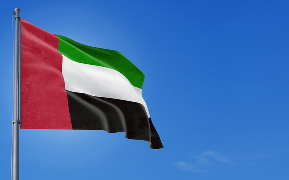 United Arab Emirates flag waving in the wind against deep blue sky. National theme, international concept. Copy space for text.