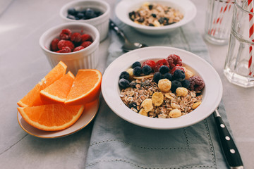 Breakfast: homemade granola with raspberries and blueberries. Homemade granola and raspberries. Top view, copy space.
