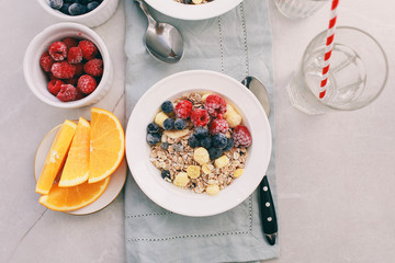 Breakfast: homemade granola with raspberries and blueberries. Homemade granola and raspberries. Top view, copy space.