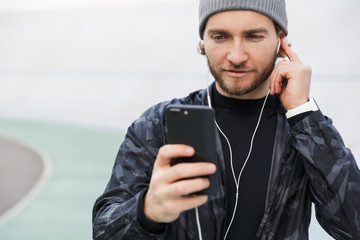 Motivated young fit sportsman listening to music