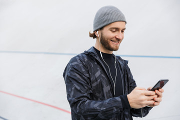 Motivated young fit sportsman listening to music