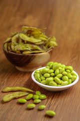 Edamame Beans Still lifeFresh boiled edamame beans isolated on wooden background