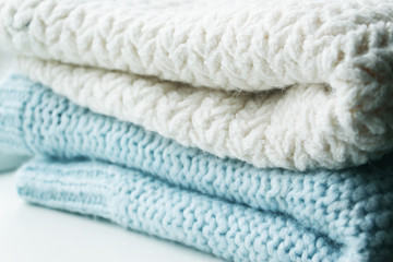 Knitting. Patterns. Natural yarn. Cotton. Wool. White and blue background.