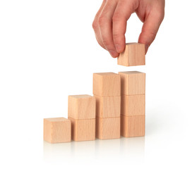 Closeup of man making bar chart with wooden cubes