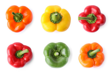 Set of different ripe bell peppers on white background, top view