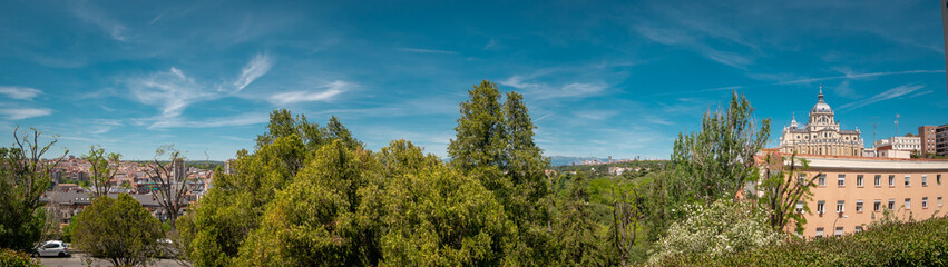 Panoramic view of Almudena cathedral from the famous park Las Vistillas in the downtown Madrid, Spain on a sunny day during the traditional festival in May called San Isidro in the capital of Spain