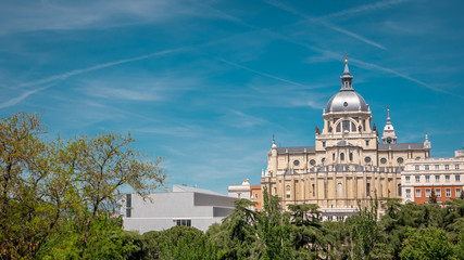 Obraz premium Panoramic view of Almudena cathedral from the famous park Las Vistillas in the downtown Madrid, Spain on a sunny day during the traditional festival in May called San Isidro in the capital of Spain