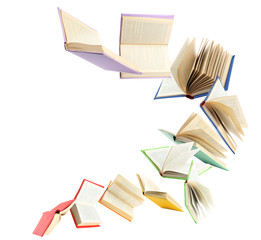 Colorful hardcover books flying on white background