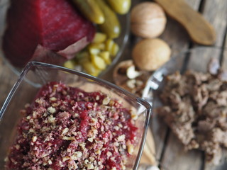 Salad roast beetroot, liver, nuts and pickles. Home kitchen. Wooden ancient background.