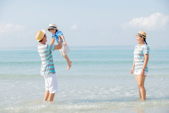 Happy Asian Family  Enjoy On The Beach Together