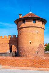 Panoramic view of the medieval Teutonic Order Castle in Malbork, Poland - external defense walls with lower castle gate tower and drawbridge over the moat