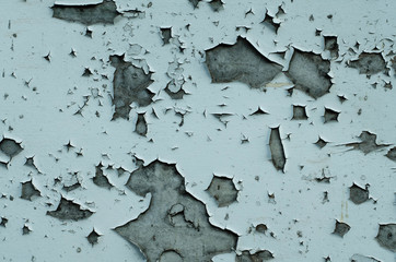 Old peeling paint on a wooden wall. Texture of painted wood. Cracked paint.