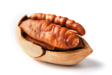 Pecan isolated on white background. Close-up, macro. A nut in a shell.