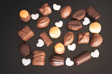 Delicious chocolates and on a dark background.