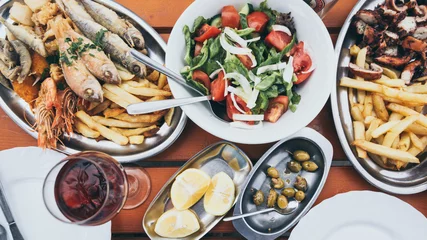 Aluminium Prints Cyprus Flat lay of Cyprus fish and seafood meze with olives, lemon and Greek salad
