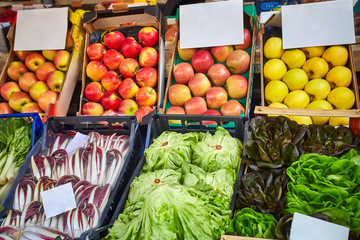 Boxes on the market with fruits and vegetables.
