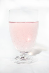 raw pink coconut water in glass