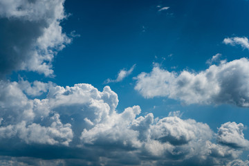 Glowing clouds on a background of blue sky. White fluffy luminous cloud