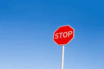 Stop sign against the blue sky.