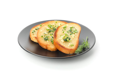 Plate of toasted bread slices with garlic isolated on white background