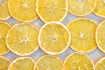 Fototapeta na wymiar Slices of dried orange on a gray cloth. Fruit background.