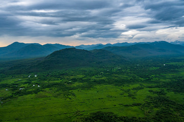 Panoramic view of the city Petropavlovsk-Kamchatsky and volcanoes: Koryaksky Volcano, Avacha Volcano, Kozelsky Volcano. Russian Far East, Kamchatka Peninsula.