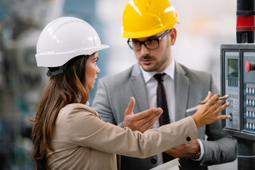 Architects working on construction project. Man and woman discussing work. 