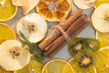 Fruit mix background. Dried fruit orange Apple pear kiwi and cinnamon sticks.